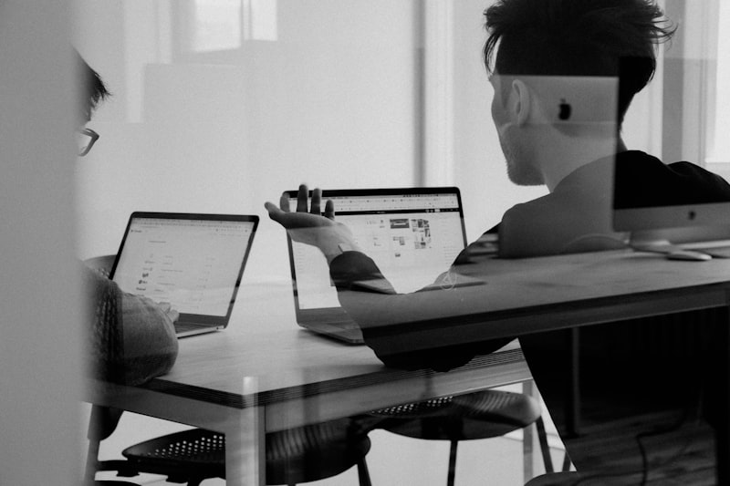 Startup team collaborating around a table with laptops